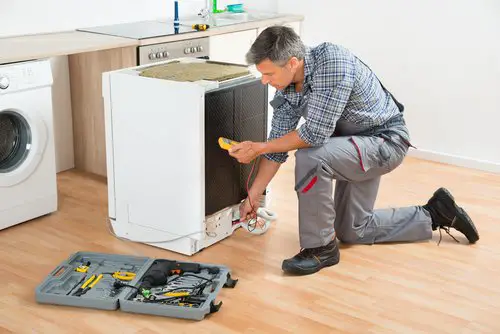Technician Checking Dishwasher With Digital Multimeter