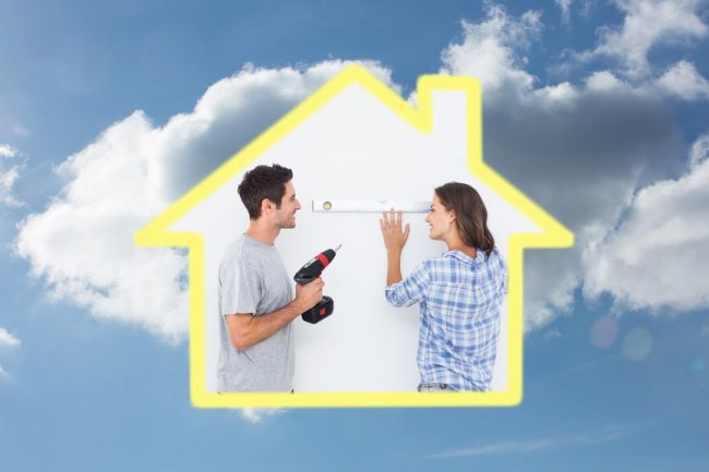 Cheerful man and his wife doing home improvements together against cloudy sky Cheerful man and his wife doing home improvements together against cloudy sky
