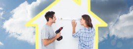 Cheerful man and his wife doing home improvements together against cloudy sky
