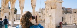 woman taking pictures of ruins